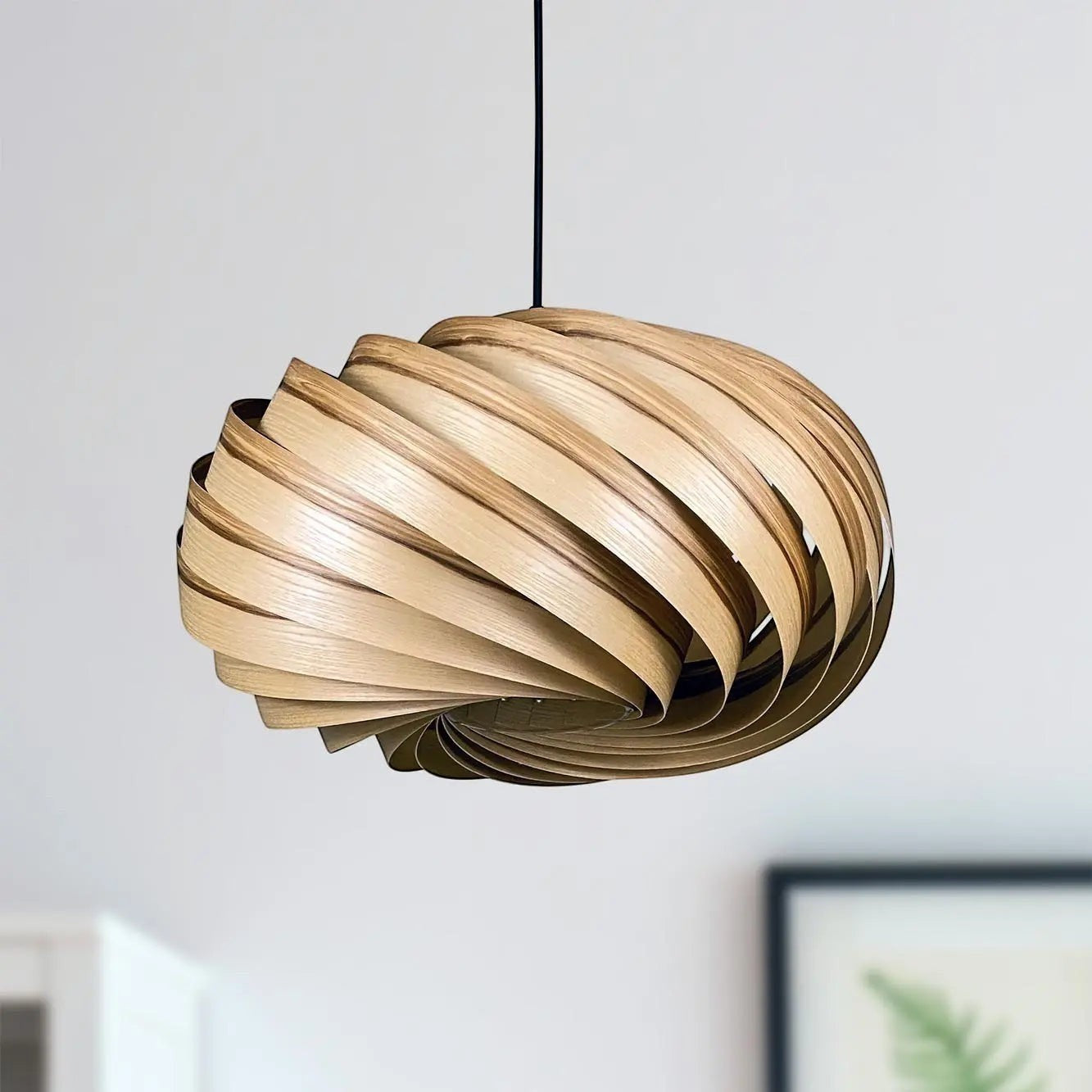 Gofurnit Quiescenta pendant lamp shade made of olive ash wood with a swirling design, 45cm diameter.