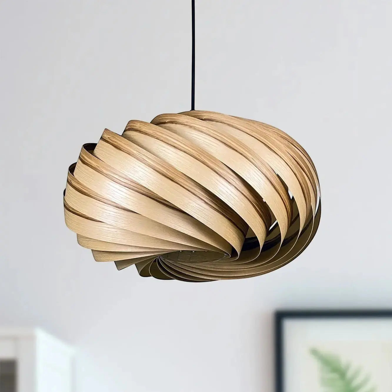 Gofurnit Quiescenta pendant lamp shade made of olive ash wood with a swirling design, 45cm diameter.